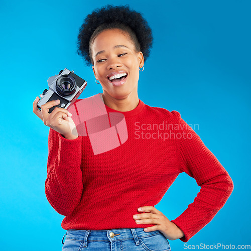 Image of Photographer woman, thinking and camera in studio for photoshoot, memory and magazine by blue background. Young journalist girl, retro tech and lens for paparazzi, newspaper or content creator job