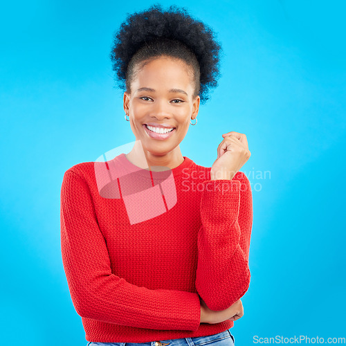 Image of Studio, portrait and black woman with a smile, natural beauty and confidence with afro, fashion or thinking with hand or gesture. Blue background, African girl and mindset for goals or happiness