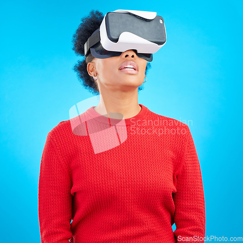 Image of VR, metaverse and digital glasses with woman watching a video with augmented reality. Studio, female person and blue background with future technology and online web user with 3d virtual network