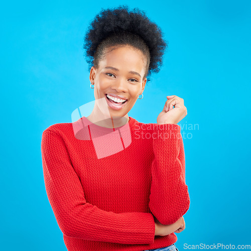 Image of Studio, portrait and happy black woman with natural beauty and confidence with afro hairstyle and casual fashion. Smile, African girl and laughing with a mindset of happiness on blue background