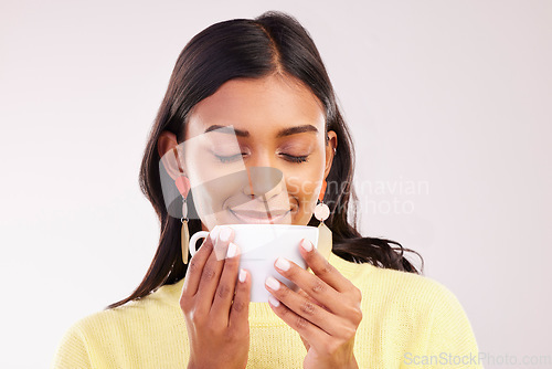 Image of Woman, coffee and smile in studio with thinking, smell and aroma with fashion, relax or drink by white background. Gen z girl, happy student and memory with cup for coco, matcha or espresso with idea