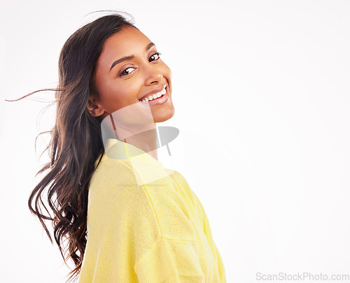 Image of Hair, wind and Indian woman in studio portrait with white background for fashion, makeup or confidence with natural beauty. Face, smile and young model with freedom and happiness with space or mockup