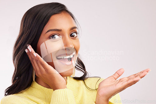 Image of Excited, wow and portrait of a woman on a studio background with mockup for marketing. Happy, amazed and face of a girl or model with a gesture, surprise and space for a deal or announcement