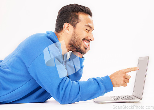 Image of Smile, laptop and man pointing on studio floor isolated on a white background. Computer, happy or person on ground for social media, streaming movie or film, video or show on internet with technology