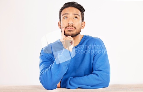 Image of Choice, thinking and space with man and idea in studio for confused, brainstorming and question. Doubt, solution and choice with asian person on white background for why, opportunity and mockup