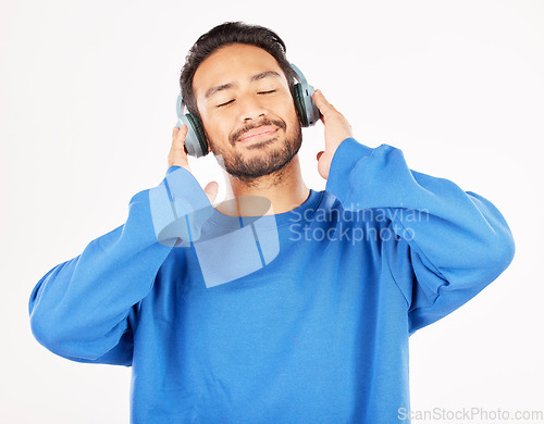 Image of Asian man, headphones and music in studio, white background and relax while hearing podcast subscription. Happy male model listening to calm audio, streaming sound and radio media with technology