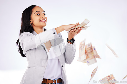 Image of Money, rain and a woman lottery winner in studio on a white background in celebration of a bonus or promotion. Cash, finance and payment with a happy young female excited about investment growth