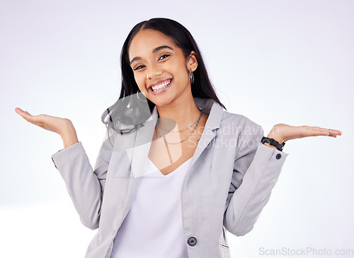 Image of Happy, shrug and portrait of a businesswoman in a studio with a choice, decision or option expression. Smile, happiness and professional female model with a dont know hand gesture by gray background.