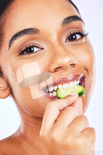 Image of Portrait, cucumber and Indian woman in studio for health, diet and detox, nutrition or wellness. Fruit, slice and face of lady with natural, vegan or organic snack for weight loss, fiber or hydration