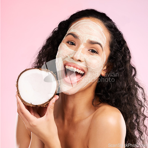 Image of Mask, facial and portrait of woman with coconut for wellness, beauty and cosmetics on pink background. Dermatology, skincare and female person with fruit for organic detox, natural face and cleaning