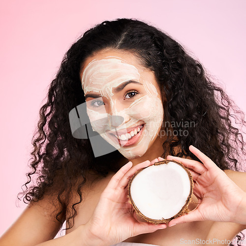 Image of Beauty, facial mask and portrait of woman with coconut for wellness, skincare and cosmetics on pink background. Dermatology, fruit and female person for organic detox, natural face and glow in studio