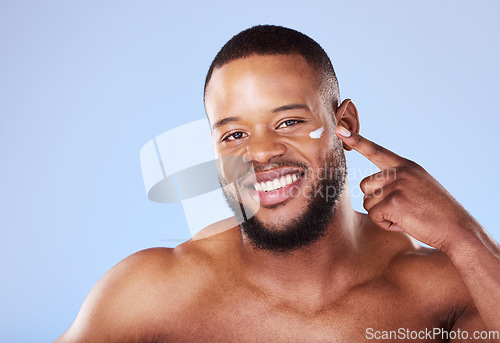 Image of Beauty, skincare and cream with portrait of black man in studio for sunscreen, cosmetics and spa treatment. Facial, self care and mockup with person on blue background for lotion, wellness and health