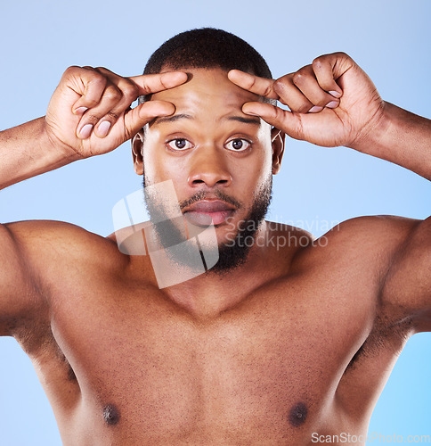 Image of Skincare, wrinkle and portrait of black man in studio hand on forehead for aging skin check on blue background. Fine lines, anxiety and face of African male model with worry for dermatology problem