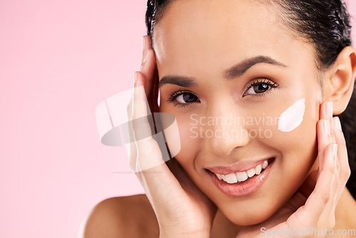 Image of Cream, beauty and face of a woman with skin care, dermatology and natural glow. Closeup of a young female model with a smile for moisturizer, cosmetic space or sunscreen on pink background in studio