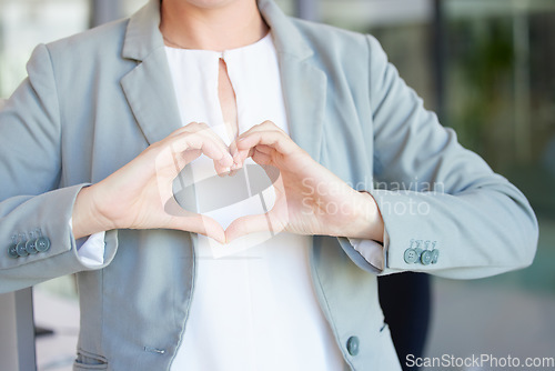 Image of Hands, heart and business woman with love emoji for care, kindness and like review in office. Closeup of female worker with finger shape for thank you, trust and sign of hope, support icon and peace