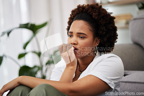 Image of Depressed, sad and african girl in home with anxiety for future with upset expression. Worry concern and remembering with female person in living on floor with problems or mental health with memory.