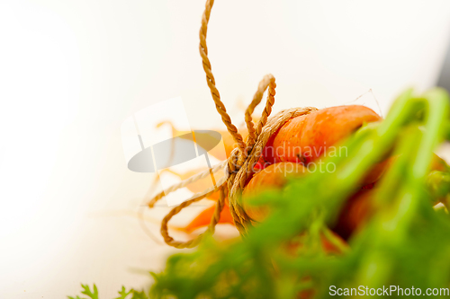 Image of baby carrots bunch tied with rope
