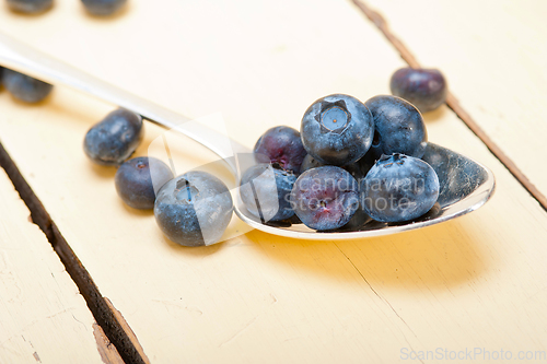 Image of fresh blueberry on silver spoon