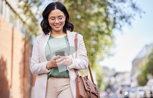 Image of Phone, city and happy business woman for outdoor communication, networking and social media. Chat, typing and mobile search of young professional person walking and travel in urban street for contact