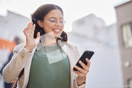 Image of Business, woman and phone with video call in the city and contact with network connection, communication or conversation. Happy, wave and person speaking on mobile or hello, gesture and greeting