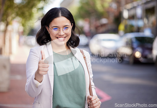 Image of Thumbs up, portrait and business woman in the city, street or professional worker with success, agreement or thank you. Hand, sign and happy worker in urban, town or walking to office building