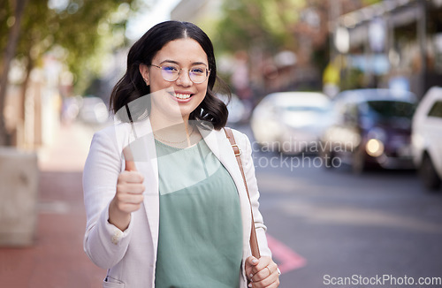 Image of Business woman, thumbs up and portrait in the city, street or professional worker with success, agreement or thank you. Hand, sign and happy worker in urban, town or walking to office building