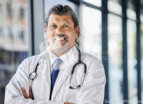 Image of Doctor, healthcare portrait and arms crossed in clinic or hospital of patient support, leadership or management. Face of senior medical person with professional health services and proud job