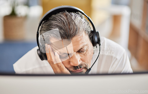 Image of Exhausted, customer service and male consultant sleeping in his office doing an online consultation. Fatigue, burnout and tired mature man telemarketing agent taking a nap with a headset in workplace