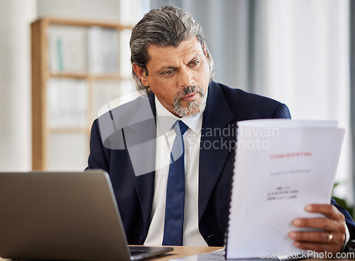 Image of Lawyer, confidential and paperwork with man reading patient file and documents in office. Compliance, legal report and attorney employee in a law firm with government contract and policy planning