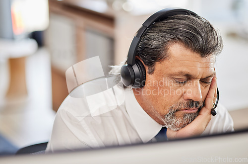 Image of Fatigue, sleep and male call center consultant in his office while doing online consultation. Exhausted, burnout and tired mature man telemarketing or customer support agent with headset in workplace