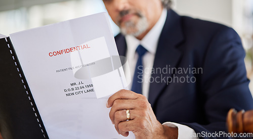 Image of Lawyer, confidential and paperwork with hands holding patient file and documents in office. Compliance, legal report and attorney employee in a law firm with government contract and policy reading