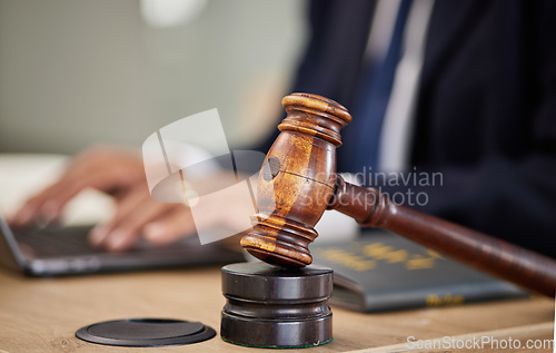 Image of Judge, hammer and man hands on laptop for legal research, typing report and compliance, justice or contract management. Attorney, advocate or lawyer person on computer and gavel for article or rules