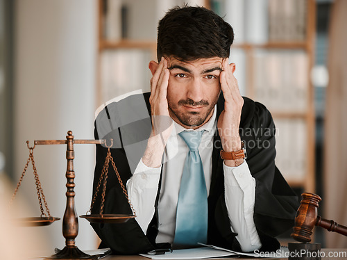 Image of Judge man, stress headache and office for thinking, solution or problem solving with worry for case. Advocate, lawyer or attorney with legal hammer, paperwork or idea with fatigue for court evidence