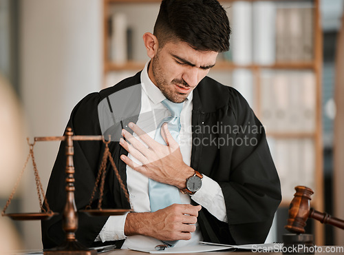 Image of Lawyer man, chest pain and office with stress, tired or burnout for cardiovascular problem at desk. Judge, attorney or advocate with heart attack, emergency or injury for lungs, breathing or accident