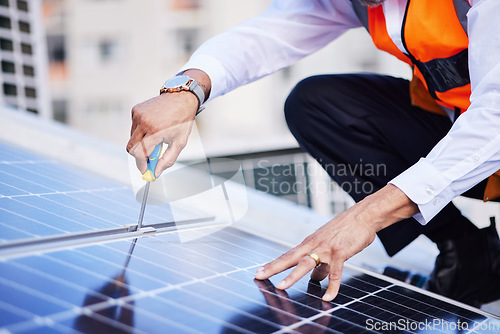 Image of Solar panels, person hands and screwdriver for engineering maintenance, sustainability and development on rooftop, Industry worker with eco friendly grid, tools and photovoltaic installation in city