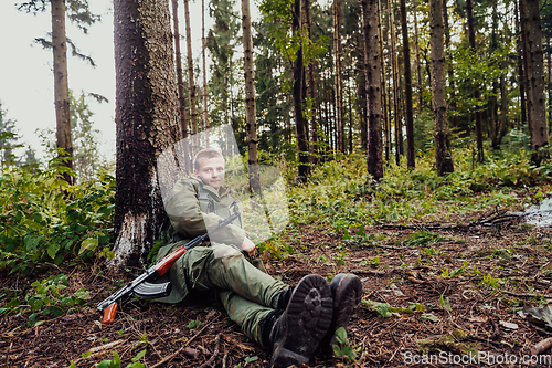 Image of A terrorist on a break from warfare, resting during heavy war fare and attack