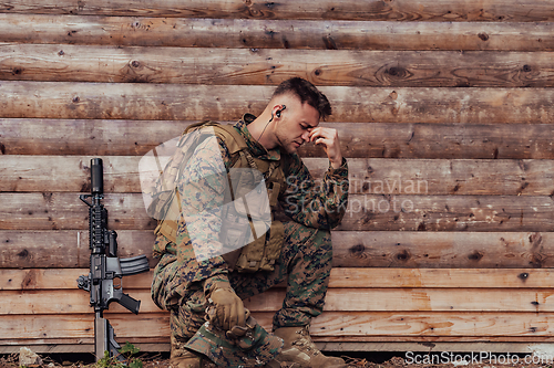 Image of Upset soldier has psychological problems holding his head