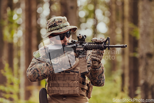 Image of A modern warfare soldier on war duty in dense and dangerous forest areas. Dangerous military rescue operations