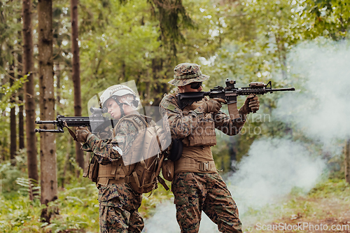 Image of Modern Warfare Soldiers Squad Running in Tactical Battle Formation Woman as a Team Leader