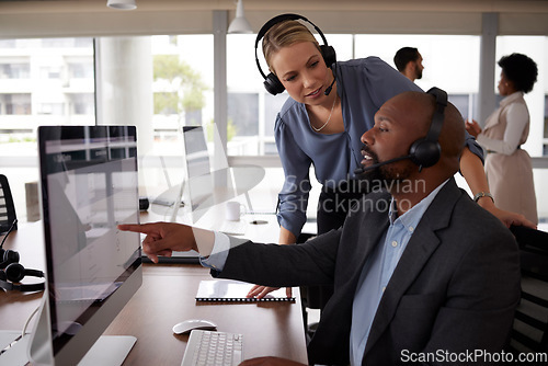 Image of Call center training, talking and employee with a manager for help, advice or telemarketing work. Diversity, computer and a black man and woman in customer service coaching and discussion at a desk