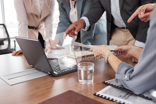 Image of Hands, meeting and business people with a laptop and report for analysis, investment or trading. Discussion, computer and corporate employees at a desk for teamwork on financial analytics together