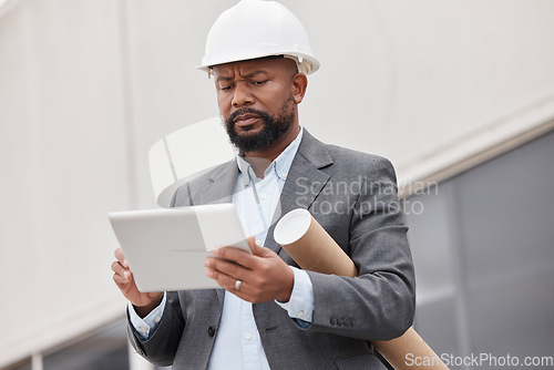 Image of Tablet, blueprint and an architect manager planning a development project for commercial property. Technology, research and construction with a black man manager reading a floor plan design online