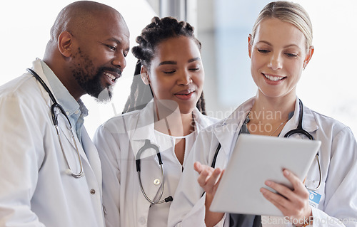Image of Smile, healthcare and doctors reading on a tablet for results, medical advice or planning. Happy, typing and a surgeon with African employees and technology for help, collaboration or cardiology