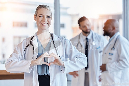Image of Healthcare, heart and hands with portrait of doctor in hospital for medical, support and kindness. Motivation, wellness and medicine with woman and gesture in clinic for cardiology, care and emoji