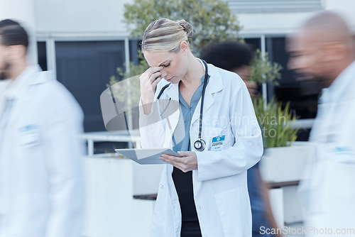 Image of Tablet, doctor and woman with stress in busy hospital, fatigue and burnout. Tech, medical professional and person with problem, crisis or challenge, headache and anxiety for mistake, fail or accident