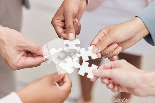 Image of Business people, hands and puzzle for teamwork, mission and problem solving of challenge, synergy and cooperation. Closeup of employees with jigsaw for integration, collaboration or planning solution