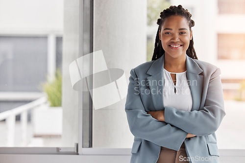 Image of Portrait, mockup and management with a black woman arms crossed in the office for corporate leadership. Smile, leader and a happy female manager or boss standing in the professional workplace