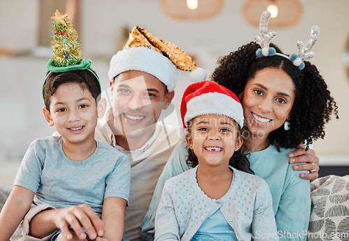 Image of Family home, parents and kids in Christmas portrait, hat or smile on sofa for celebration in living room. Mother, father and happy young children for xmas party, event or holiday for culture on couch