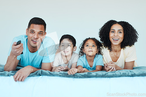 Image of Father, mother and children on bed, watching tv and smile for comedy, comic movie and cartoon in family home. Happy parents, kids and television show with streaming, subscription and relax together