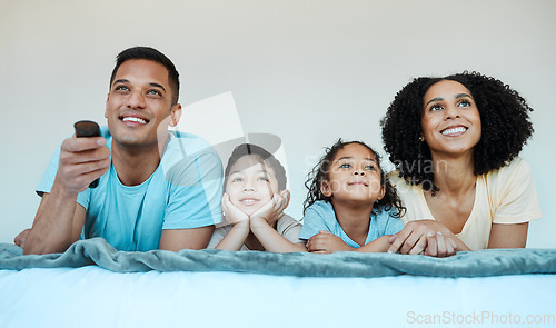 Image of Mom, dad and children on bed, watching tv and smile for comedy, funny movie or cartoon in family house. Happy parents, kids and watch television show with streaming, subscription and relax together